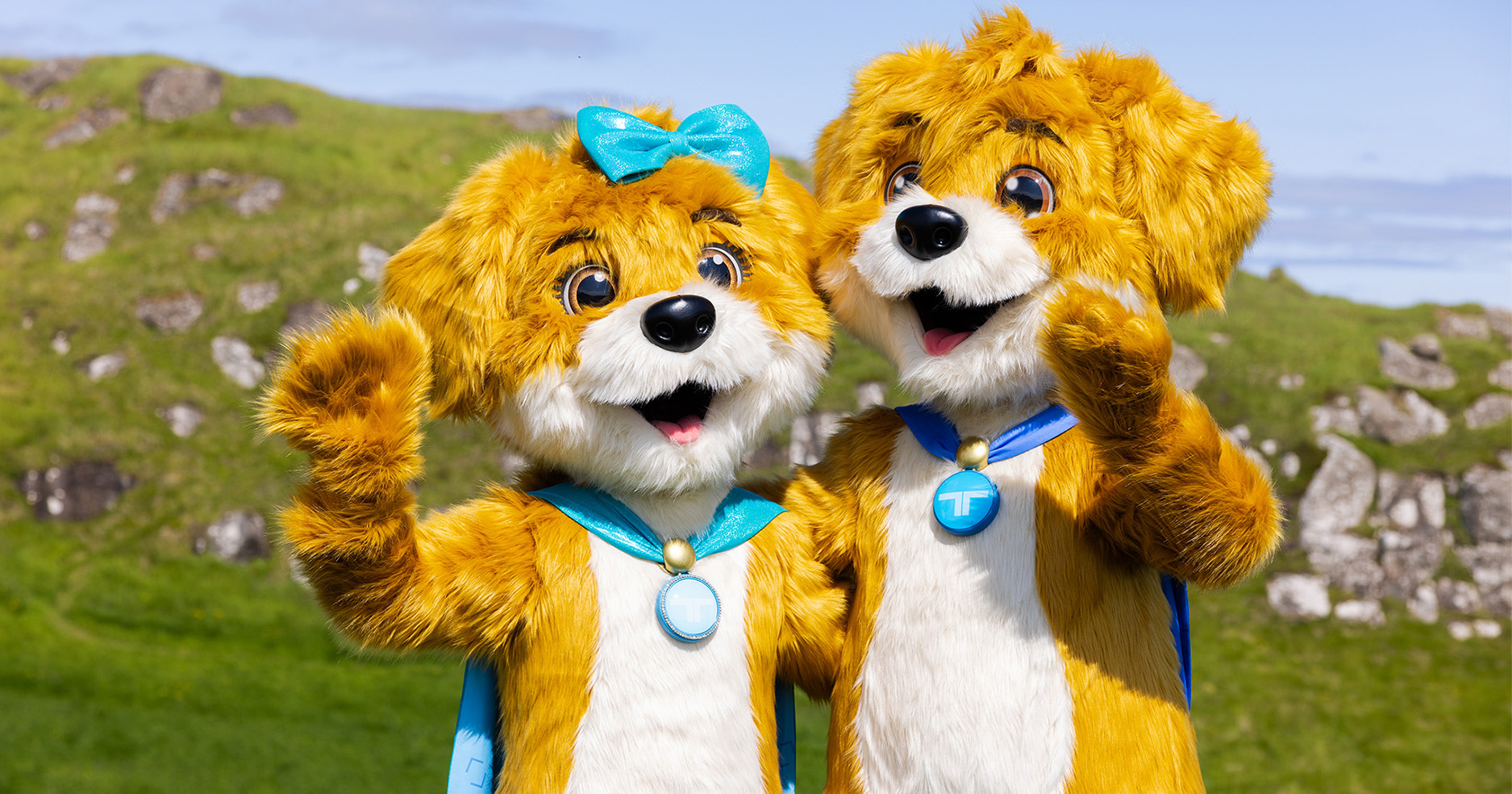Two puppy mascot costumes of Treysti and Tita