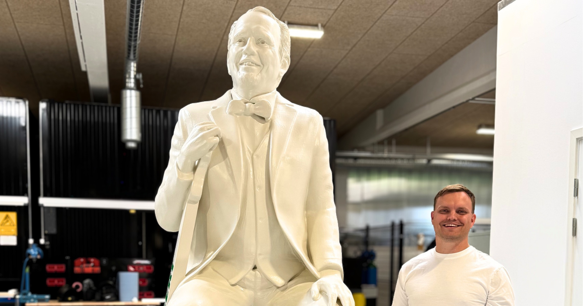 A life-sized 3D-printed statue of Jacob Haugaard positioned next to a person to demonstrate scale
